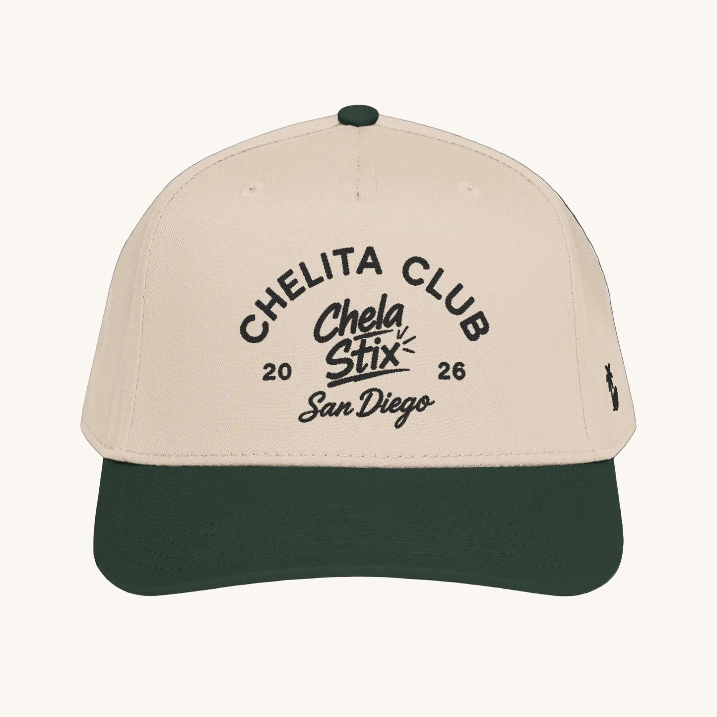 A structured baseball cap with a light beige crown and a dark forest green visor, featuring black embroidered text on the front that reads 'CHELITA CLUB Chela Stix 2026 San Diego' and a small black logo on the side.