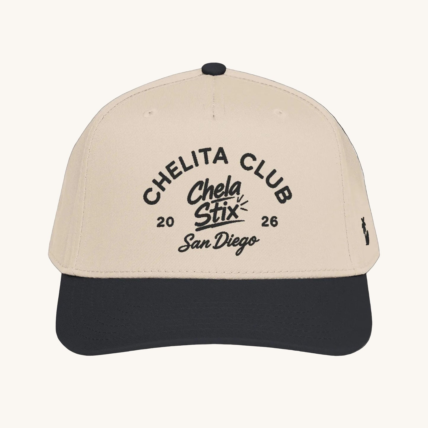 A structured baseball cap with a light beige crown and a dark forest green visor, featuring black embroidered text on the front that reads 'CHELITA CLUB Chela Stix 2026 San Diego' and a small black logo on the side.