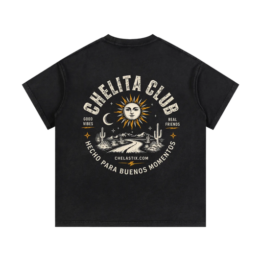 A black short-sleeve t-shirt shown from the back, featuring a large cream-colored graphic print with a sun, moon, cactus, and the text 'CHELITA CLUB' and 'HECHO PARA BUENOS MOMENTOS'.