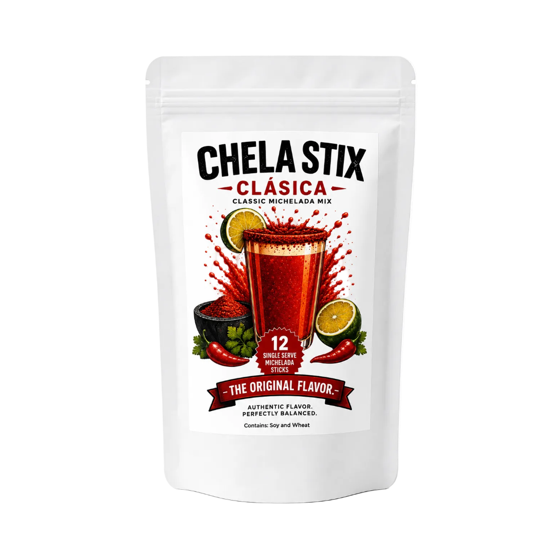 A white stand-up pouch of Chela Stix Clásica Classic Michelada Mix, featuring a colorful label with a glass of red drink, lime slices, chili peppers, and bold black and red text on a white background.
