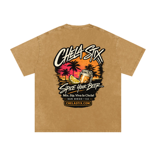 A tan short-sleeve t-shirt with a large graphic print on the front featuring the brand name 'CHEA-SIX' in stylized white lettering, a tropical sunset scene with palm trees, a beer can, and a slice of lime, with the text 'SPICE YOUR BEER' and 'Mix. Sip.