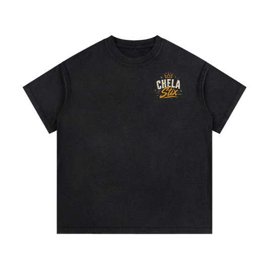 A black short-sleeve crewneck t-shirt with a small graphic on the left chest featuring a crown and the text 'CHELA Star' in white and gold, displayed on a solid white background.
